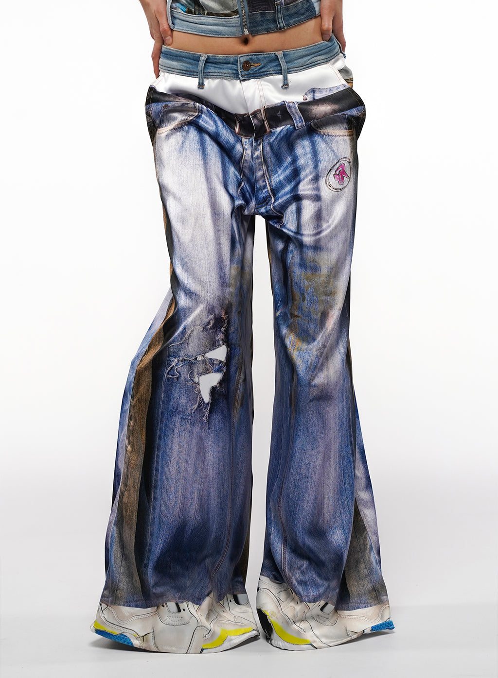 Distressed blue jeans with a white background